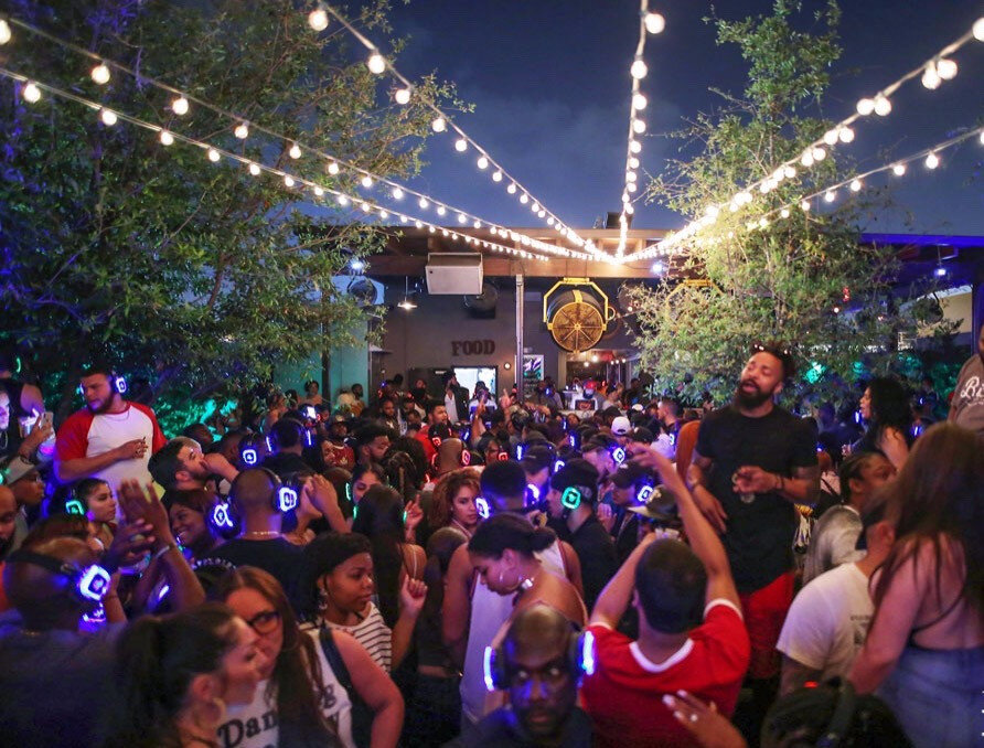 Packed night at Brick Wynwood under the string lights